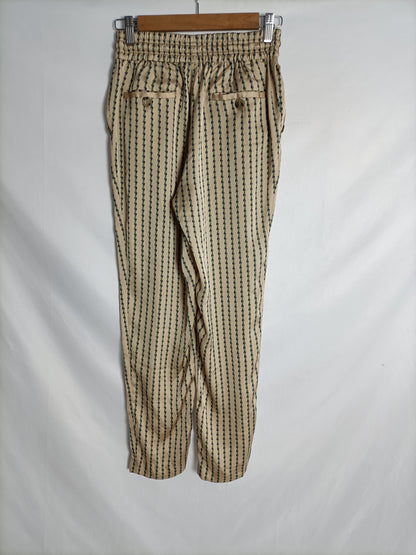 PURIFICACIÓN GARCIA. Pantalón satinado beige estampado. T 36